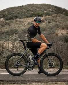 a man is riding his bike down the road