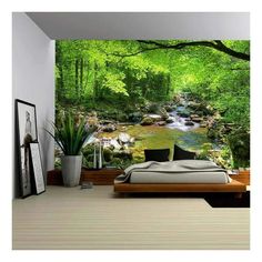 a bedroom with a bed, desk and large wall mural in the middle of it