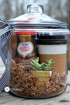 a glass jar filled with coffee and succulents