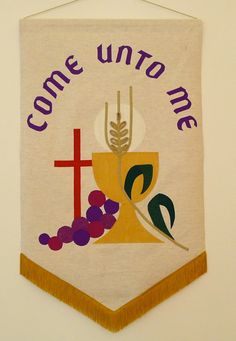 a banner hanging on the wall that says come unto me with a cross and grapes