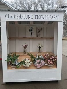 a white flower shop with flowers on display