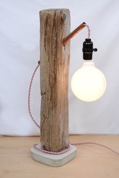 a light that is sitting on top of a wooden pole with a cord attached to it