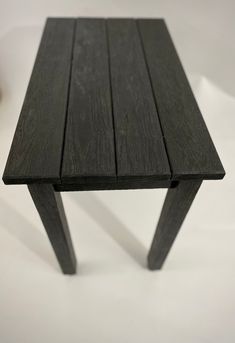 a wooden table sitting on top of a white surface