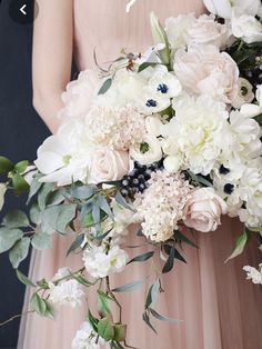 a woman holding a bouquet of flowers in her hands