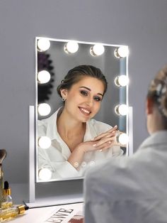 a woman is looking at herself in the mirror