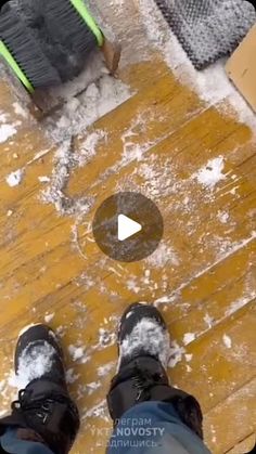 a person standing on top of a wooden floor next to a hole in the ground