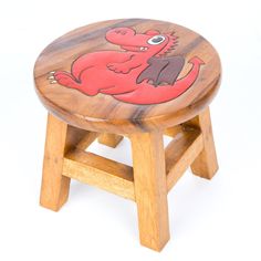 a wooden stool with a red dragon painted on it