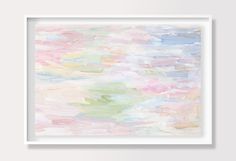 an abstract painting with pastel colors and white frame hanging on the wall above it