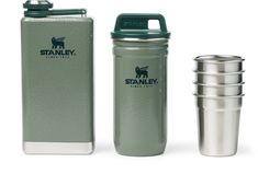 the stanley stainless steel flask is next to two cups and a shaker cup