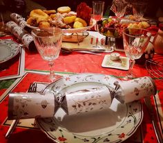 a table set with plates, silverware and glasses