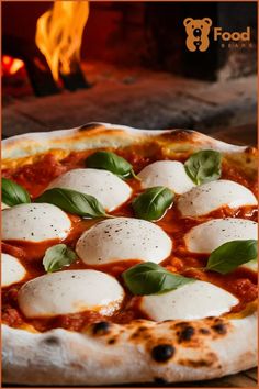 a pizza with mozzarella and basil on it sitting in front of a fire