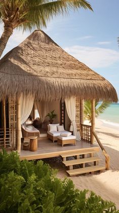 a hut on the beach with lounge chairs and palm trees