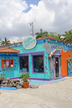 a brightly colored building with the word worship painted on it