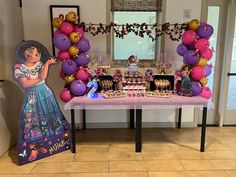 a table topped with lots of candy and balloons