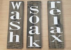 two wooden signs with the words wash, sasak and whisk on them