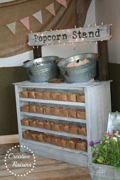 the popcorn stand has two buckets on it and is decorated with bunting flags