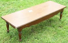 an old wooden table sitting in the grass