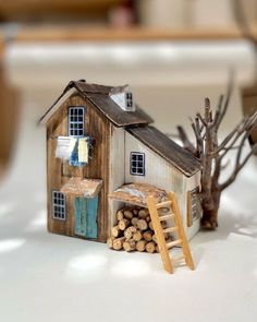 a miniature house made out of wood and logs