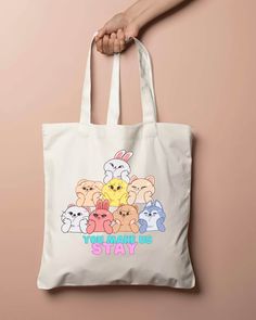 a white tote bag with cartoon characters on it and the words stay busy written in pink