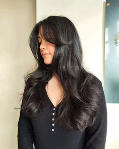 Discover the allure of jet-black hair, shimmering with health and elegance. Long layers create a weightless, flowing movement, while a side-swept fringe gently contours the face. Styled into sophisticated loose waves, this blowout exudes classic dynamism. Intrigued? Click for our gallery and join us on Pinterest for more! ** Photo Credit: Instagram @myu.hm Jet Black Hair