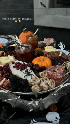 a platter filled with halloween food and drinks