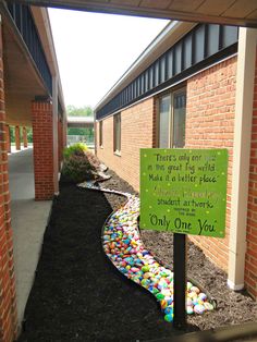 a sign in front of a brick building that says elementary school was asked to color his unique individual stone