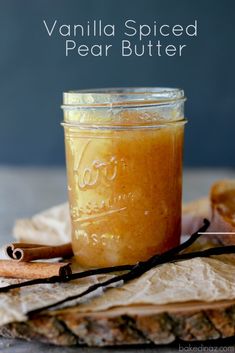 vanilla spiced pear butter in a jar with cinnamon sticks