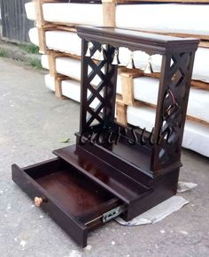 an old wooden jewelry box sitting on the ground in front of stacks of mattresses