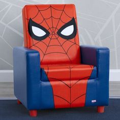 a spiderman chair sitting in front of a wall with the eyes drawn on it