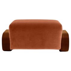 an orange velvet couch with wooden legs