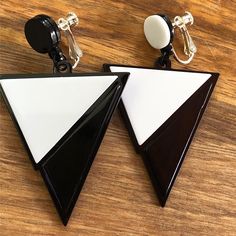 Dangling clip on earrings. Large asymmetrical black and white dangling triangles on hinged screwback  closures. Adjustable, lightweight, retro look.  Earrings are not intended to be worn while sleeping bathing or swimming. Not recommended for children. See more: https://www.etsy.com/ca/shop/CleverLittleEars CANADIAN PRICES INCLUDE GST/HST WHERE APPLICABLE. ETSY WILL CALCULATE ANY PST OWING AT CHECKOUT. While the cost of shipping makes returns or exchanges impractical, please do contact me with any concerns about your order and we will work together to address them.  By law, European buyers have 14 days from receipt to request a return. Return shipping costs will not be covered by CleverLittleEars.