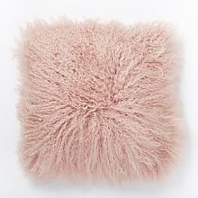 a pink fluffy pillow on a white background