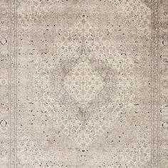 an antique rug with intricate design in grey and beige colors, on a white background