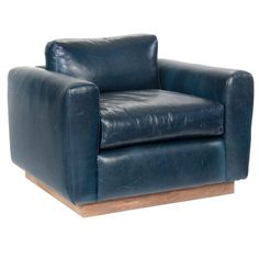 a blue leather chair sitting on top of a wooden base