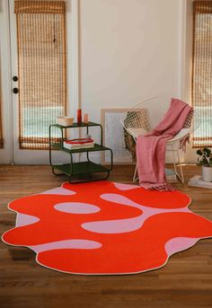 an orange and pink rug in the middle of a room