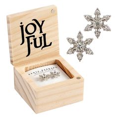 a wooden box with two earrings in it and the word joyful written on top