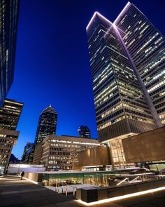 skyscrapers lit up at night in the city