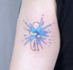 a person with a blue tattoo on their arm