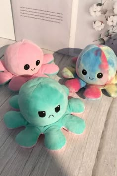 three stuffed animals sitting next to each other