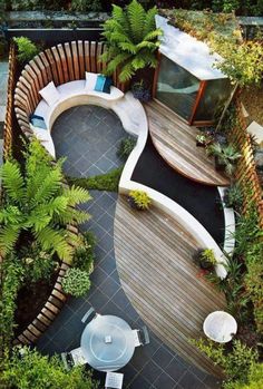 an aerial view of a patio with seating and plants on the ground, from above