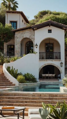 a house with a pool in front of it and stairs leading up to the outside