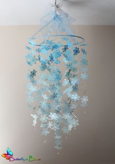 a chandelier hanging from the ceiling with snowflakes on it's sides