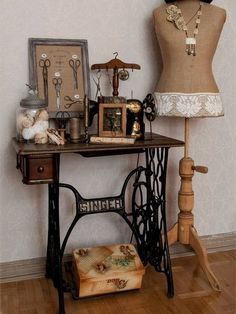 an antique sewing machine and mannequin are on display