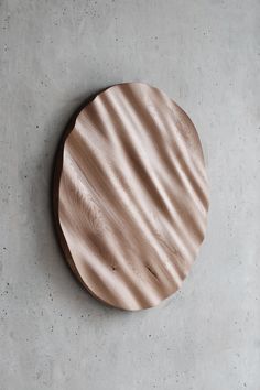 a round wooden object sitting on top of a cement floor