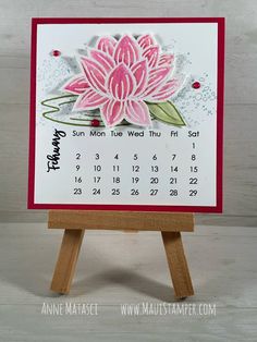 a calendar card with a pink flower on it