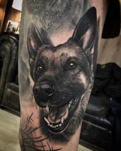 a black and white tattoo of a wolf