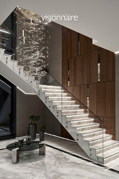 a modern staircase with glass railings and wood paneling