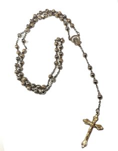 Wow!! How cool is this vintage piece! This is an amazing Italian made rosary that would look stunning on anyone. This rosary is made of metal and is a great gift idea for a baptism, communion or a wedding. This absolutely incredible rosary is gold-toned and has a depiction of both the Virgin Mary and a Crucifix. Get this rosary fo ryourself or for someone in your life who loves vintage pieces! Very unique piece to add to your vintage collection❤ Stamped Made in Italy. Length: 20 in (51 cm) US SH Vintage Gold Rosary With Crucifix, Vintage Silver Handmade Rosary, Handmade Vintage Silver Rosary, Handmade Silver Vintage Rosary, Vintage Rosary, Gold Rosary, Cross Jewelry Necklace, Catholic Rosary, Gifts Vintage