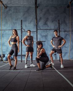 a group of men and women posing for a photo in a crossfit gym