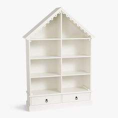 The cutest way to display her books or toys is within the cozy walls of our dollhouse shelving. HOW IT IS CONSTRUCTED Expertly crafted of MDF (medium density fiberboard). Our exclusive Simply White finish is applied by hand for exceptional richness, durability and depth of color. GREENGUARD Gold Certified to contribute to healthier indoor air, keeping you and your family safer. DETAILS THAT MATTER Features 8 roomy cubbies (including area under roof) and has two drawers. Hardware is finished in d Pottery Barn Bookcase, Dollhouse Bookcase, Glamorous Furniture, Kids Doll House, 3 Shelf Bookcase, Big Kids Room, Simply White, Bookshelves Kids, Baby Furniture